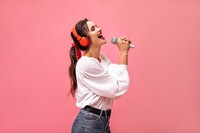 emotional-lady-in-red-headphones-singing-in-microphone-bright-beautiful-girl-in-white-blouse-and-in-jeans-with-black-belt-posing197531-18620